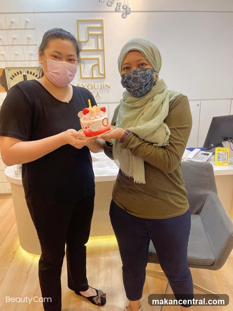 Two women holding a cake