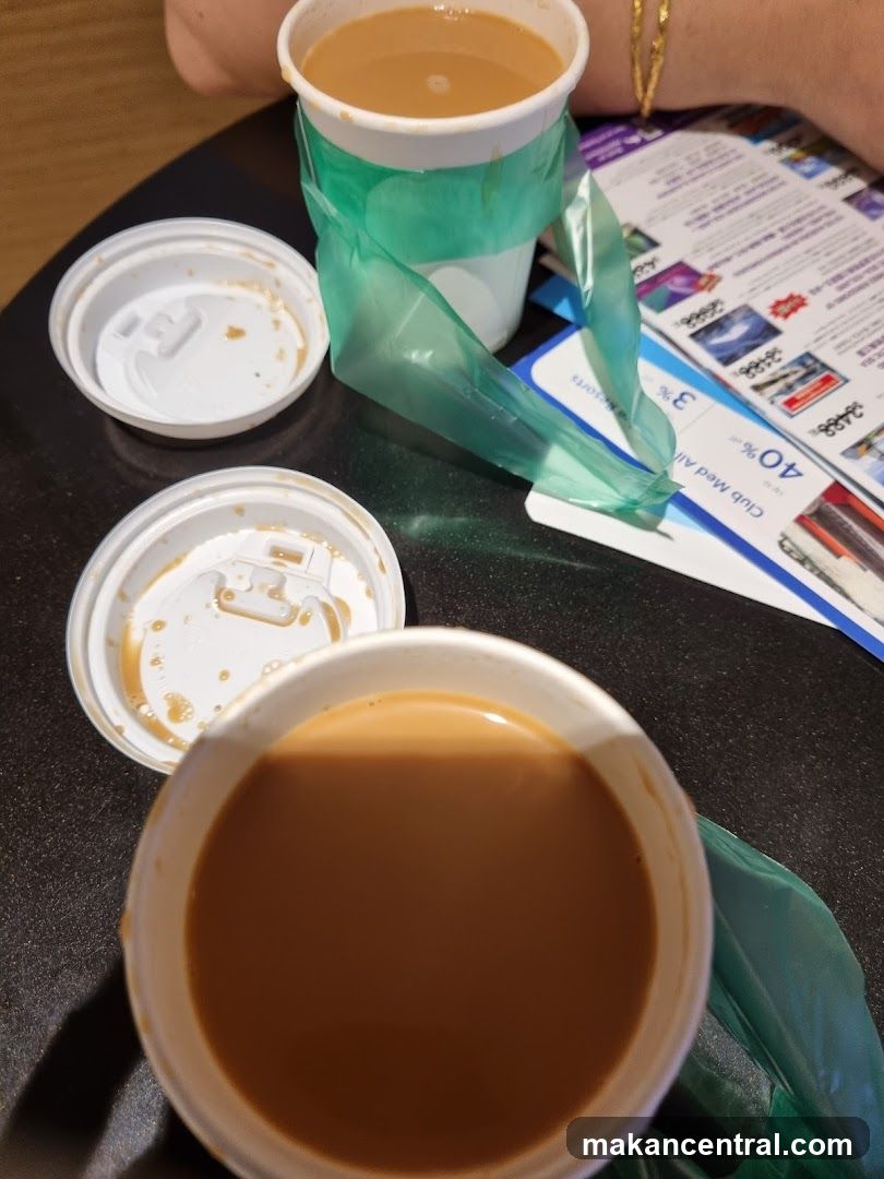 Two cups of coffee with lids