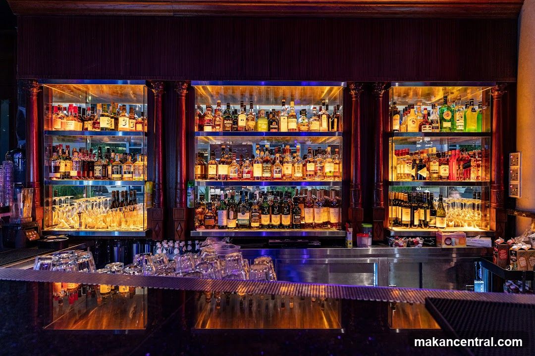 Bar with illuminated shelves of liquor bottles