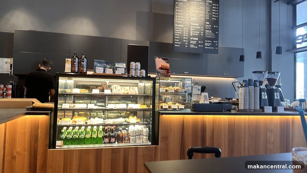 Coffee Shop Counter with Pastries and Drinks