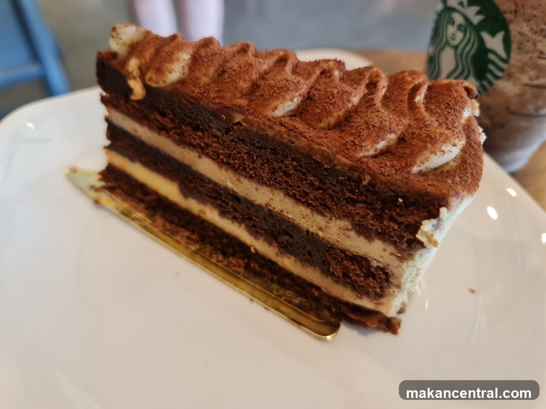 Chocolate cake with cream and cocoa powder