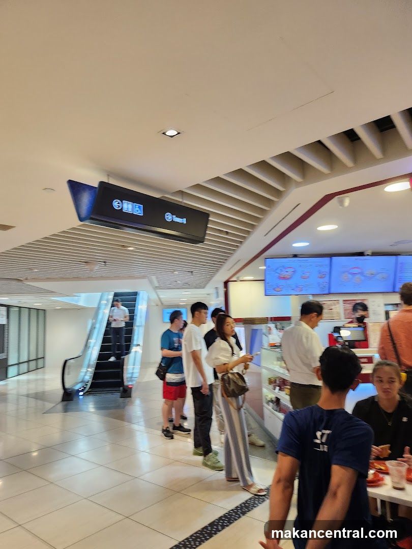 People queuing at a food counter
