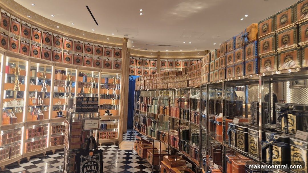 Interior of a store with shelves stocked with tea or coffee tins.