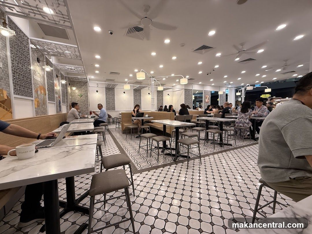 Busy cafe interior with patrons dining and working