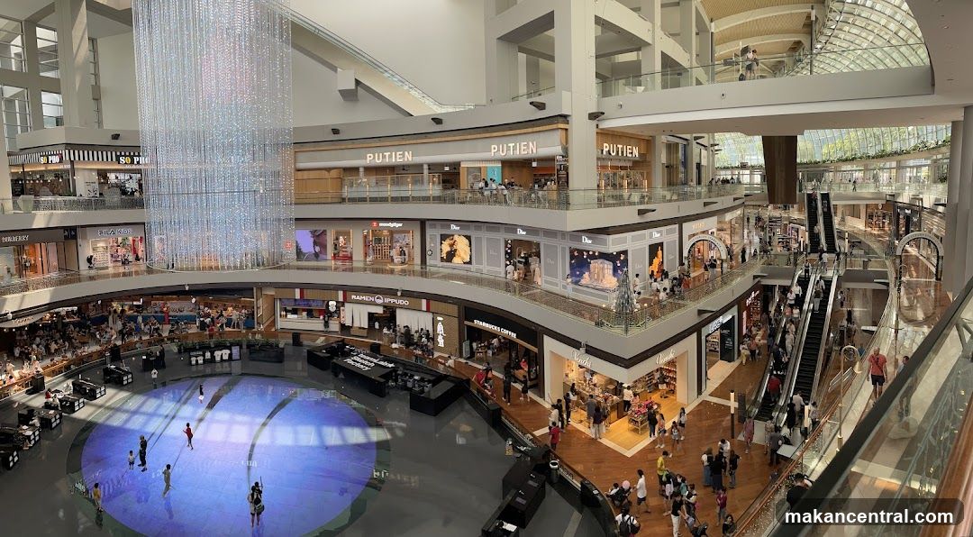 Interior of a multi-level shopping mall with a large central atrium