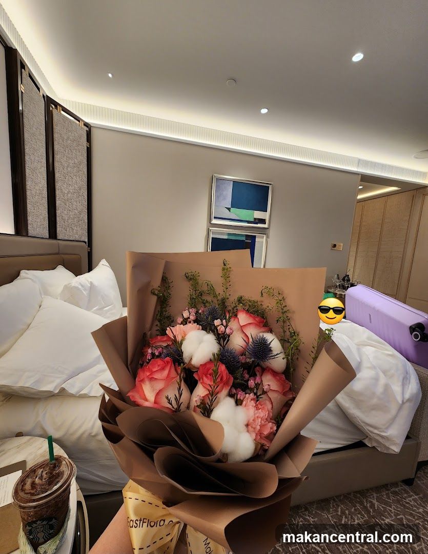 Hotel Room with Flowers and Drink