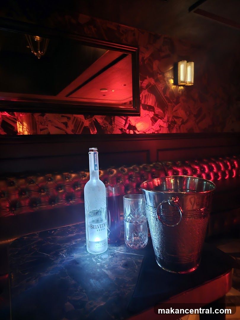 Table with Belvedere Vodka bottle, glasses, and ice bucket