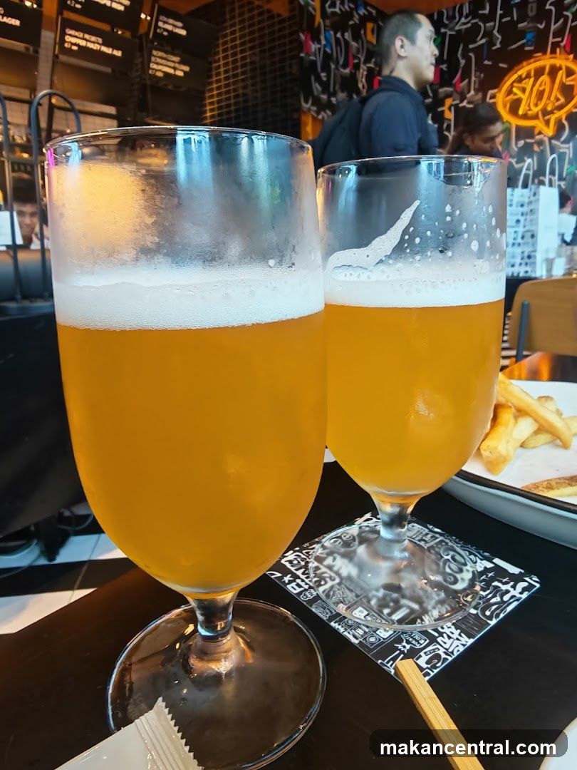 Two glasses of beer with fries