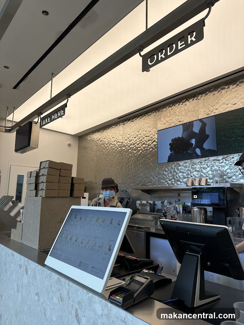 Order and Take Here Signs Above Counter