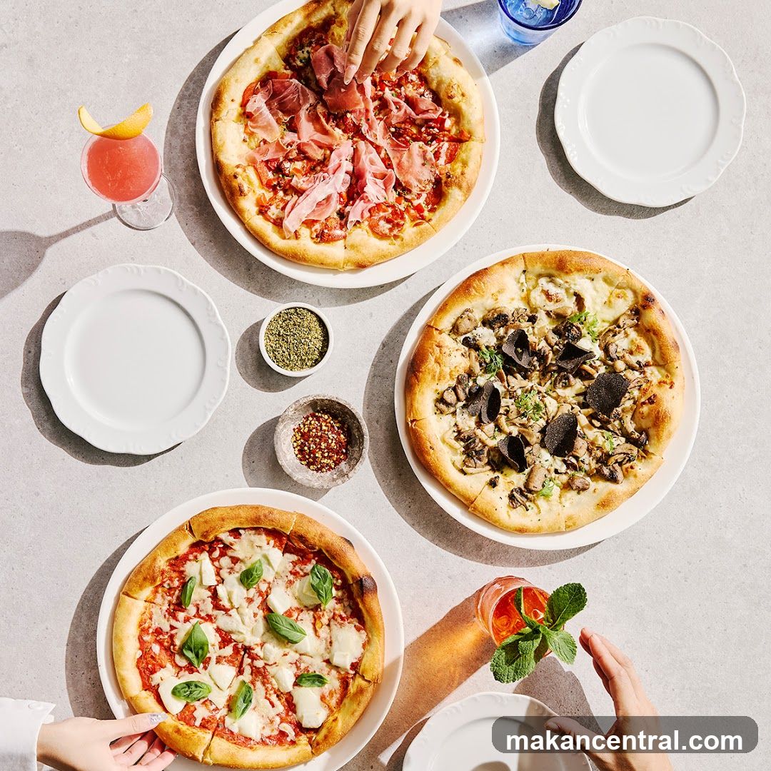 Three pizzas and cocktails on a table