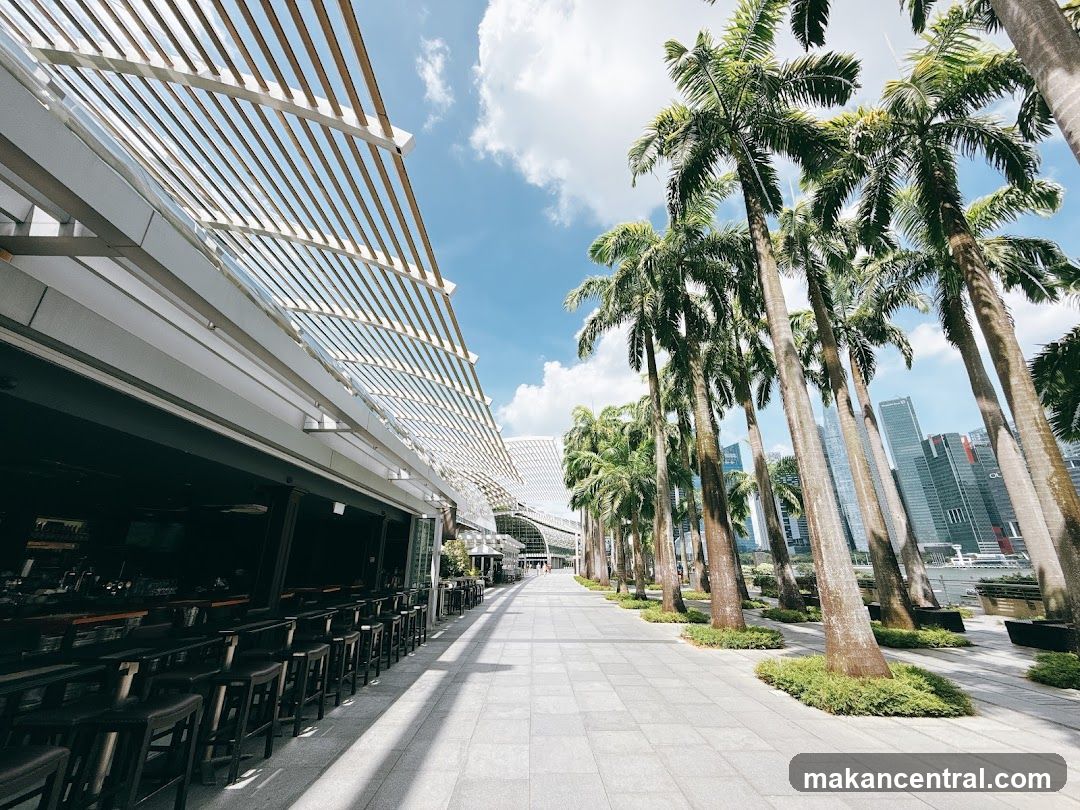 Outdoor Seating Area with Palm Trees and City Skyline