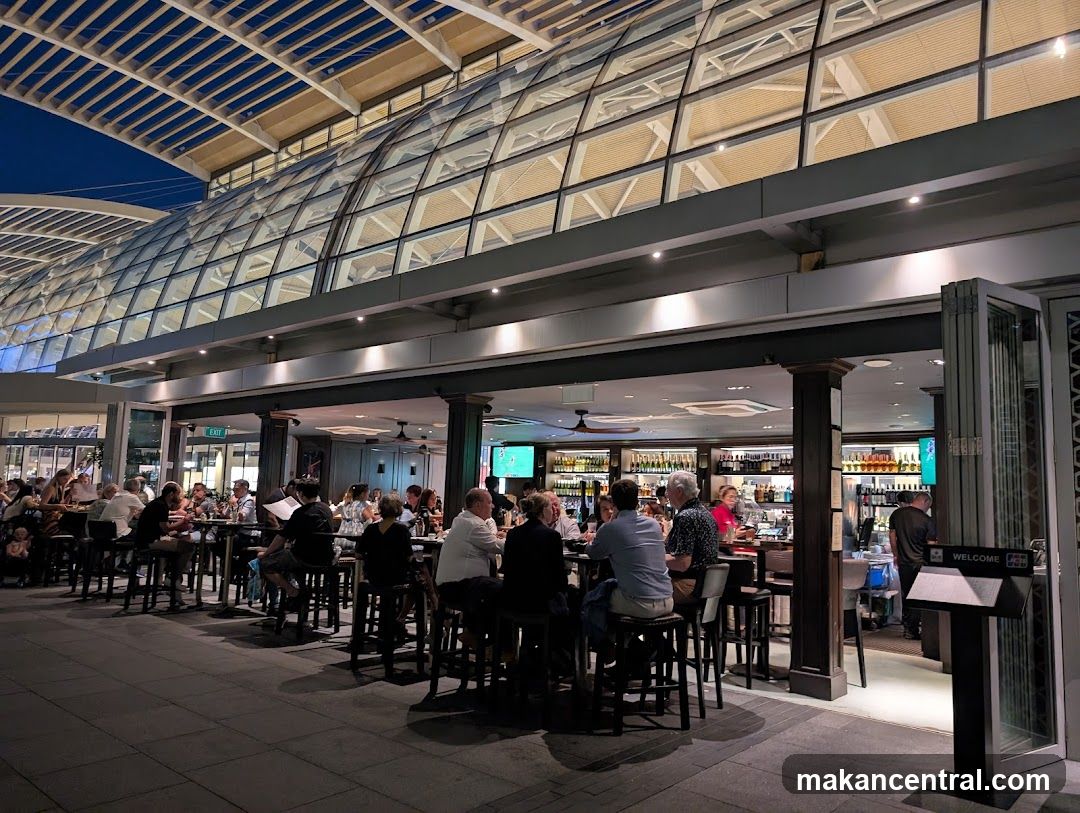 Busy bar and restaurant with patrons seated at tables and bar