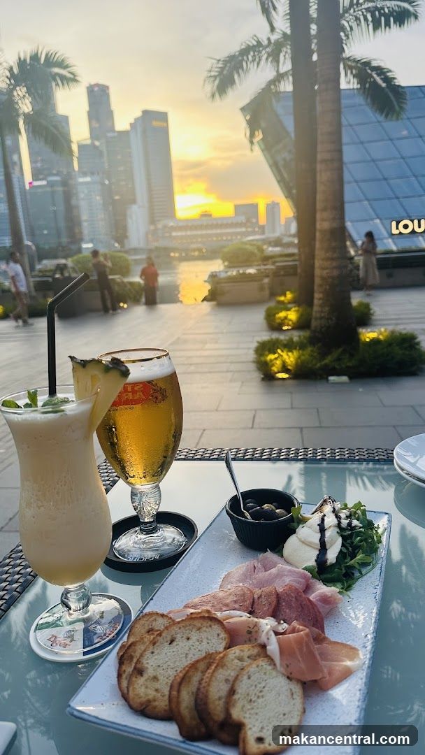 Outdoor dining with city skyline at sunset