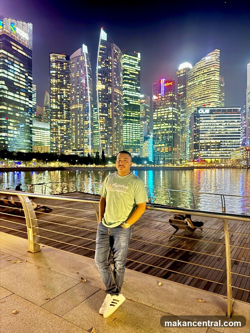 Man Posing in Front of City Skyline at Night