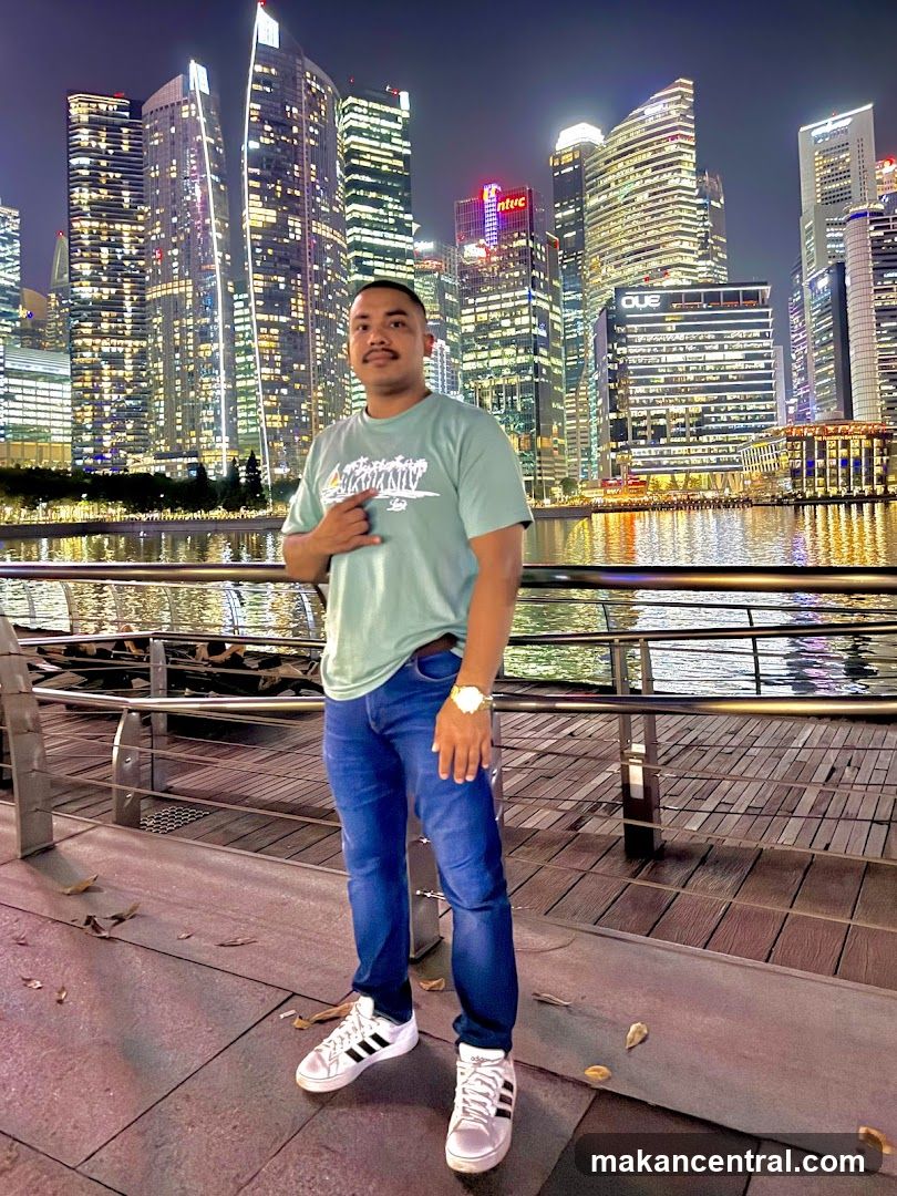 Man Posing in Front of City Skyline at Night
