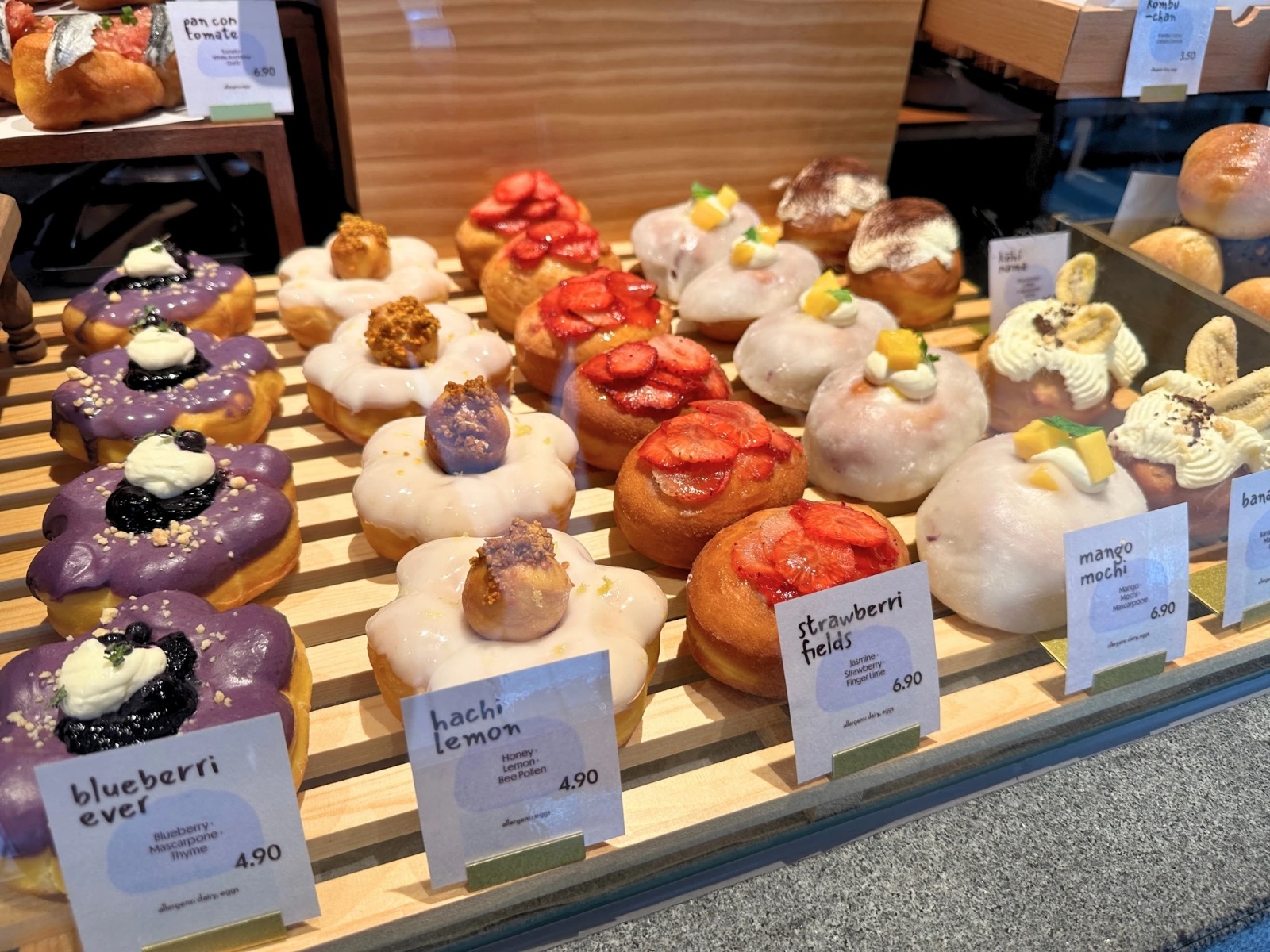 Cloudmills display case with Blueberri Ever, Hachi Lemon, Strawberri Fields and Mango Mochi doughnuts