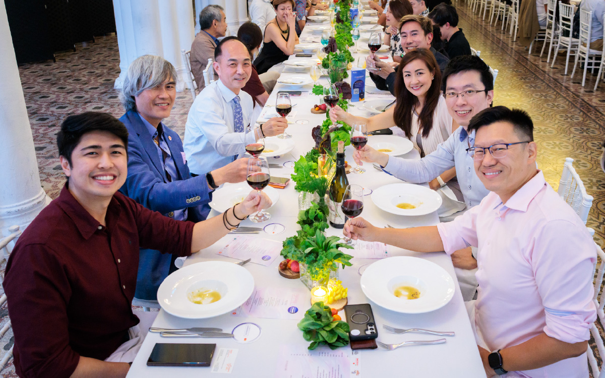 Diners gathered at a long communal heritage table styled with elegant centrepieces at Singapore Food Festival 2026