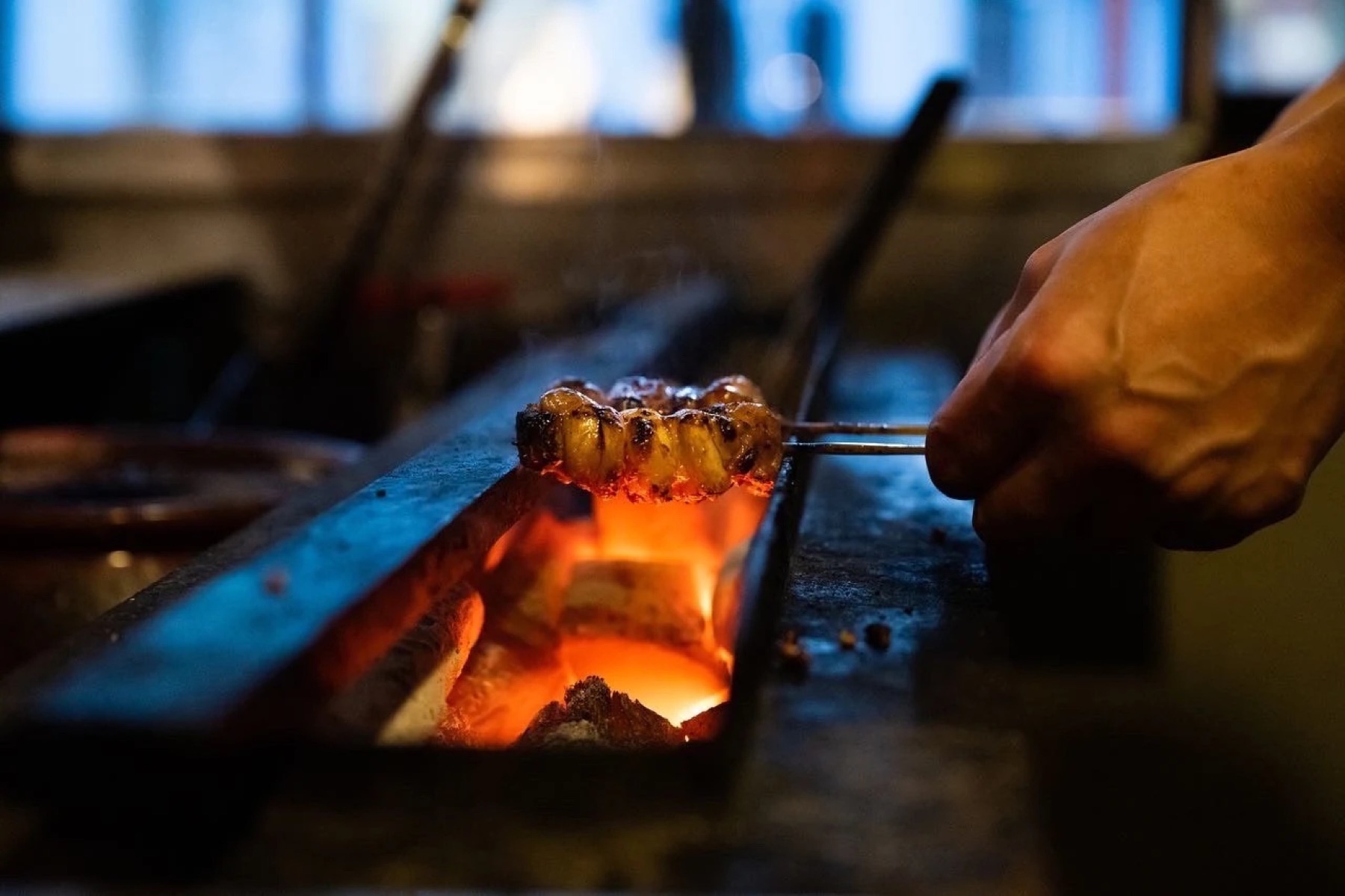A chicken skewer over binchotan at Torimitsu, coming to Tanuki Raw's balcony at Orchard Central