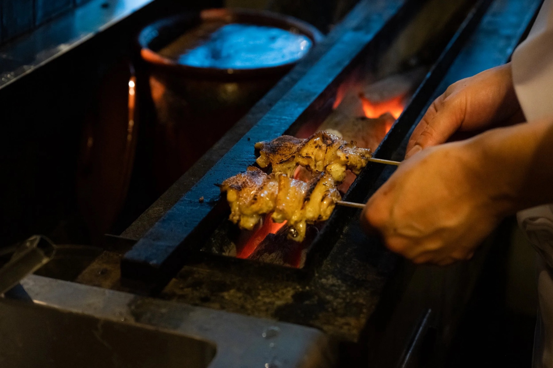 Yakitori skewers over charcoal at Torimitsu, the Tokyo counter cooking at Tanuki Raw Orchard Central from 28 October 2026